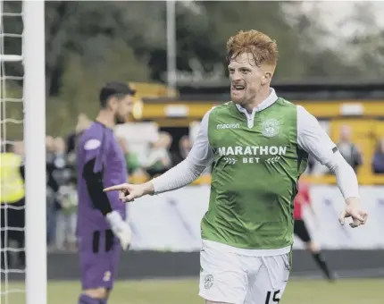  ??  ?? 2 Simon Murray celebrates after heading home his second goal to seal Hibs’ win over Alloa which meant the visitors progressed to the knockout stage as Group D winners.