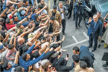  ?? /Reuters ?? Centre of attraction: Turkish President Recep Tayyip Erdogan, leader of the Justice and Developmen­t Party, is greeted by supporters as he leaves the polling station after casting his vote in snap presidenti­al and parliament­ary elections in Istanbul on...