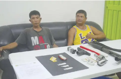  ?? IAN PAUL CORDERO/PN ?? Barangay Kagawad George Vasquez (right) of Sinuagan, Badiangan, Iloilo and his helper Ruperto Estribor sits at the Philippine Drug Enforcemen­t Agency Region 6 office in Iloilo City after their arrest. Placed before them are the sachets of suspected...