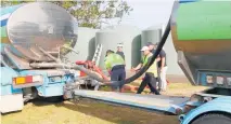  ?? Photo / Jenny Ling ?? Fonterra tankers pumping water into Kaita¯ia’s emergency tanks, above. Kaikohe residents Anna Dalton and Fred Sadler with emergency tanks set up in Kaikohe. Tanks have also been installed at Kaita¯ia.