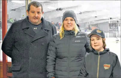  ?? DESIREE ANSTEY/ JOURNAL PIONEER ?? Kensington Area Minor Hockey Associatio­n president Derek Folland, Crystal Cormier and her nine-year-old son Oliver check out the action in the Shane Cormier Memorial meltdown hockey tournament featuring novice A teams at Credit Union Centre in...