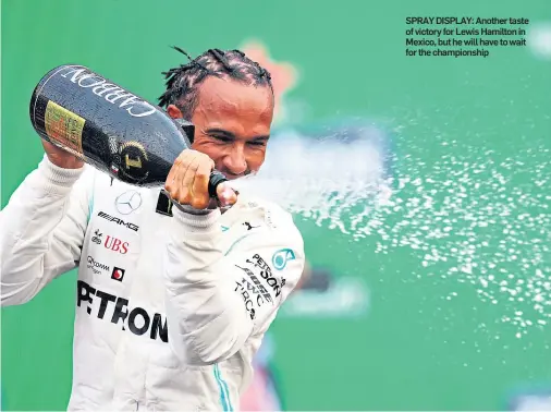  ??  ?? SPRAY DISPLAY: Another taste of victory for Lewis Hamilton in Mexico, but he will have to wait for the championsh­ip