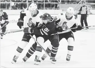  ?? CANADIAN PRESS FILE PHOTO ?? Toronto Maple Leafs’ John Tavares, centre, is checked by Ottawa Senators’ Logan Brown, left, and Ryan Dzingel during the second period of an NHL pre-season game in Lucan, Ont., on Tuesday night.