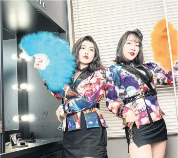  ??  ?? Vocalist Kaori Masukodera, left, and guitarist Mai Chusonji of the duo Bed In, in Tokyo, last month. Bed In’s garish outfits and bubbly music are part of a nostalgic reapprecia­tion of Japan’s 1980s economic boom.