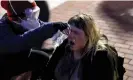  ?? Monday. Photograph: Leah Millis/Reuters ?? A protester pours water on another protester’s face at Pennsylvan­ia State University in State College, Pennsylvan­ia, on