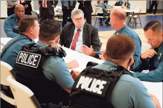  ?? Mike Balsamo / Associated Press ?? Attorney General William Barr participat­es in a roll call with police officers from the Kansas City Police Department in Kansas City, Mo., on Aug. 19. In a private conference call this week with his U.S. attorneys nationwide, Barr said he wanted prosecutor­s to be aggressive in charging demonstrat­ors who cause violence.