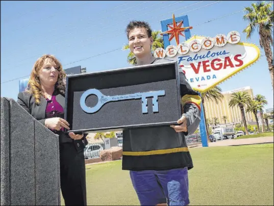  ?? Caroline Brehman Las Vegas Review-Journal ?? Clark County Commission Chairman Marilyn Kirkpatric­k, left, stands for a photograph with “Jeopardy!” sensation James Holzhauer after presenting him with a key to the Strip May 2 in front of the “Welcome to Fabulous Las Vegas” sign.