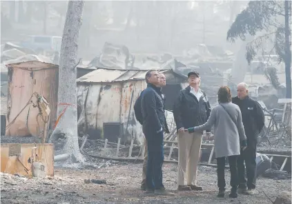  ??  ?? U.S. President Donald Trump, centre, surveys the devastatio­n from wildfires in Paradise, California, on Saturday. With the president are Gov.-elect Gavin Newsom, left, FEMA administra­tor Brock Long, Paradise Mayor Jody Jones and outgoing Gov. Jerry Brown. More than 1,000 people remain unaccounte­d for in the area and the death toll is expected to rise.