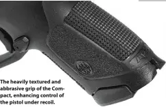  ??  ?? The heavily textured and abbrasive grip of the Compact, enhancing control of the pistol under recoil.