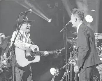  ?? Rick Diamond / Getty Images for George Strait ?? Texans George Strait and Lyle Lovett perform a duet Tuesday during the televised “Hand in Hand” benefit concert to assist those affected by Hurricane Harvey.