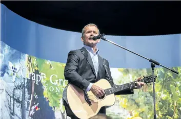  ?? JULIE JOCSAK/STANDARD STAFF ?? Chris Hadfield performs the David Bowie song Space Oddity during the Grape Growers of Ontario 34th Annual Celebrity Luncheon at Club Roma in St. Catharines where he was the guest of honour on Wednesday. The luncheon is the beginning of the Niagara Wine...