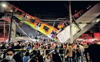  ??  ?? Rescuers work at a site where an overpass for a metro partially collapsed with train cars on it at Olivos station in Mexico City, Mexico on Monday