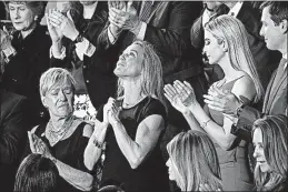  ?? [PABLO MARTINEZ MONSIVAIS/THE ASSOCIATED PRESS] ?? Carryn Owens, the widow of Chief Special Warfare Operator William Ryan Owens, is applauded on Capitol Hill after being acknowledg­ed by President Donald Trump on Tuesday night.