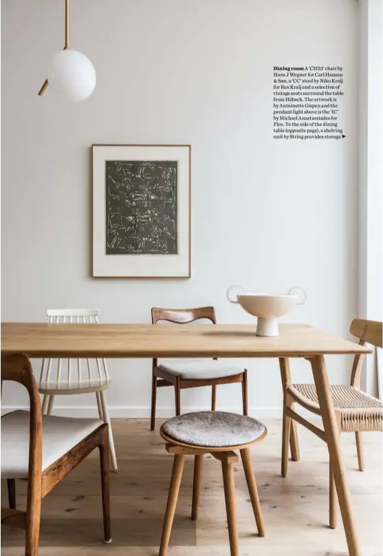  ??  ?? Dining room A ‘CH23’ chair by Hans J Wegner for Carl Hansen & Søn, a ‘CC’ stool by Niko Kralj for Rex Kralj and a selection of vintage seats surround the table from Hübsch. The artwork is by Antoinette Gispen and the pendant light above is the ‘IC’ by Michael Anastassia­des for Flos. To the side of the dining table (opposite page), a shelving unit by String provides storage