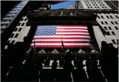  ?? JULIA NIKHINSON — THE ASSOCIATED PRESS ?? People walk past the New York Stock Exchange.