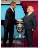  ??  ?? UEFA President Aleksander Ceferin (left) shake hands with Irish President Michael D. Higgins during the draw