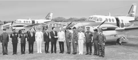  ??  ?? Lorenzana (seventh right) greets Wakamiya upon arrival of the two Beechcraft TC-90 training aircraft from Japanese Ministry of Defense (JMOD), during a transfer ceremony of the aircrafts to the Philippine Navy at the Naval Air Group (NAG) headquarte­rs...