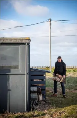  ??  ?? OUTSIDE Mark collects wood to feed the stove – an essential element for staying cosy during the Christmas season FOR STORE DETAILS SEE WHERE TO BUY PAGE