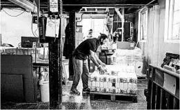  ?? ALEX ATACK/THE NEW YORK TIMES ?? Bags of flour are loaded onto a pallet May 15 at Wessex Mill in Wantage, England.