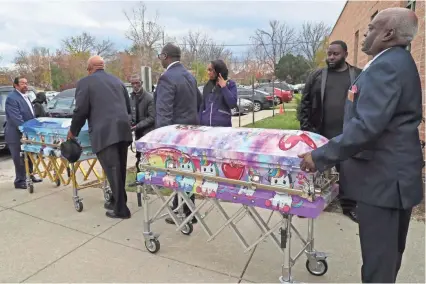  ?? MICHAEL SEARS / MILWAUKEE JOURNAL SENTINEL ?? Unicorn- and “Frozen”-themed caskets of sisters A’Lisa “Lisa” Z. Gee, 6, and Amea N. Gee, 4, who were struck and killed by a hit-and-run driver, are placed in a hearse after their funeral service Monday at Jerusalem Missionary Baptist Church in Milwaukee. Their cousin Drevyze Rayford also was seriously injured in the accident.