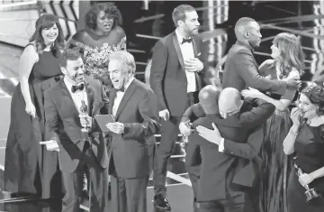  ??  ?? Host Jimmy Kimmel (second left) and Warren Beatty laugh after correcting the Best Picture Oscar from ‘La La Land’ to ‘Moonlight’ during the Oscars awards show in Hollywood last Sunday. — Reuters file photo