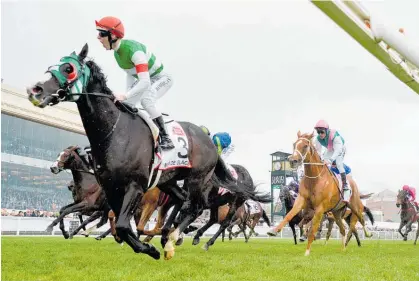  ?? Photo / Getty Images ?? Mer De Glace (Damian Lane) storms into Melbourne Cup contention as he wins the Caulfield Cup.