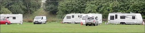  ??  ?? ‘UNBEARABLE’: The travellers’ caravans when they first arrived in the village field, prompting complaints of intimidati­on and antisocial behaviour