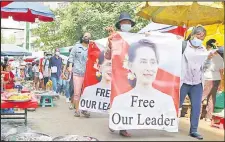  ?? Picture: AP/FILE ?? Protesters walk through a market with posters of ousted Myanmar leader Aung San Suu Kyi at Kamayut township in Yangon, Myanmar, on April 8, 2021. A Myanmar court convicted Suu Kyi of more corruption cases Monday, August 15, 2022, adding six years to prison sentence.