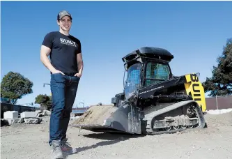  ??  ?? Built Robotics CEO Noah Ready-Campbell poses for a picture in front of the company’s autonomous track loader in San Francisco. Backed by Silicon Valley money, tech startups are developing self-driving bulldozers, drones to inspect work sites and robot...