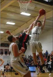  ?? DAVID TURBEN — THE NEWS-HERALD ?? West Geauga’s Mark Sexton, right, fights for a rebound against Chagrin Falls’ Josh Janus on Jan. 26.