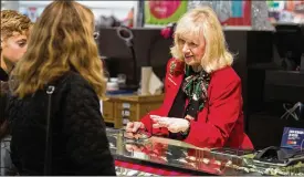  ??  ?? Barbara Cake shows watches to customers at the J.C. Penney jewelry counter in Hermitage. It is Cake’s mission to offer customers what they can’t get online.