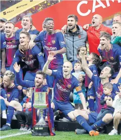  ?? AP ?? Barcelona players pose with the King’s Cup at the Wanda Metropolit­ano stadium in Madrid.