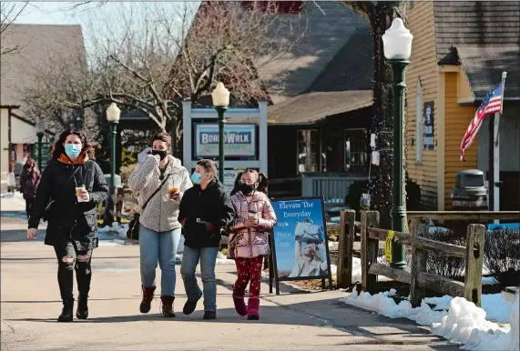  ?? PHOTOS BY DANA JENSEN/THE DAY ?? Phoebe Botticello, Olivia Lopez and Olivia’s children, Michael, 9, and Sophia, 7, all of Portland, stroll through Olde Mistick Village on a recent Saturday.