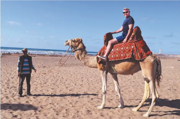  ?? CITIZEN PHOTO BY KERRY MACNAULL ?? Reporter Steve MacNaull on Rgrariya the camel at Lalla Meriem Beach in Casablanca.