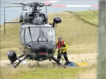  ??  ?? A water rescuer climbs on board the Otago Regional Rescue Helicopter, which was involved in the search for a missing diver.