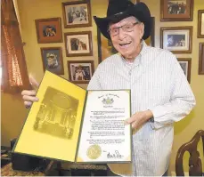  ?? DAVE SCHERBENCO/AP ?? John “Stanky” Stankovic holds one of the many citations and awards he has been given over the years in Nanticoke, Luzerne County. He will be inducted into the Internatio­nal Polka Associatio­n’s Hall of Fame this month.