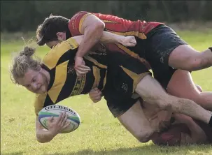  ?? Photo: Iain Ferguson, the Write Image. ?? Euan Larter feels the full force of a tackle from the Glasgow University Medics defence.