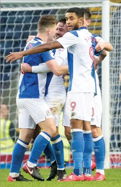  ??  ?? LUCKY MAN: Blackburn players celebrate their good luck at going ahead through Leon Best’s own goal