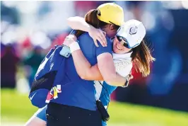  ?? The Associated Press ?? ■ Europe’s Leona Maguire celebrates with her sister Lisa after defeating United States’ Jennifer Kupcho on the 15th hole during the singles matches at the Solheim Cup golf tournament Monday in Toledo, Ohio.