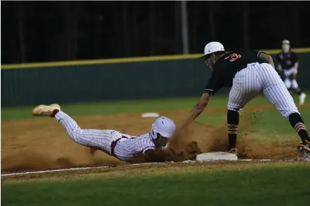  ?? (Photo by Kevin Sutton, TXKSports.com) ?? Liberty-Eylau’s Cal Jones slides into third base while Queen City’s Reggie Harrison attempts to make the tag during Monday night’s season-opening baseball game at H.E. Markham Field. The Leopards won, 9-3.