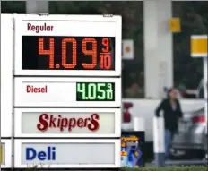  ?? ELAINE THOMPSON / AP ?? A driver fills a tank at a gas station on Friday in Marysville, Wash. consumer prices rose 6.8% for the 12 months ending in November, a 39-year high. Many economists expect inflation to remain near this level a few more months but to then moderate through 2022.