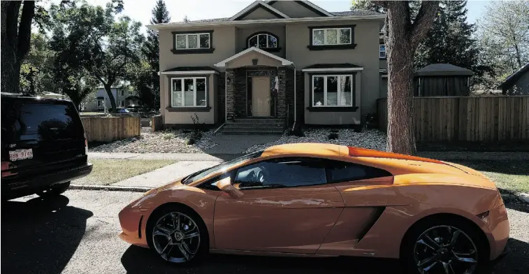  ?? Photos: John Lucas/ Edmonton Journal ?? One of Kamil Issa’s exotic cars — a Lamborghin­i — parked in front of his family’s new home in Glenora.