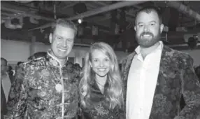  ??  ?? Daniel Bell, right, with Meghan and James Iacino, whose Seattle Fish Co. was a major sponsor of the Chinese New Year gala.