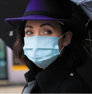  ?? Photo: Owen Breslin ?? CHALLENGIN­G TIMES: A pedestrian in a mask outside Trinity College Dublin yesterday as the coronaviru­s outbreak in Ireland intensifie­d.