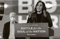  ?? Carolyn Kaster / Associated Press ?? Democratic vice presidenti­al candidate Kamala Harris speaks in Phoenix on Oct. 8 as presidenti­al hopeful Joe Biden listens.