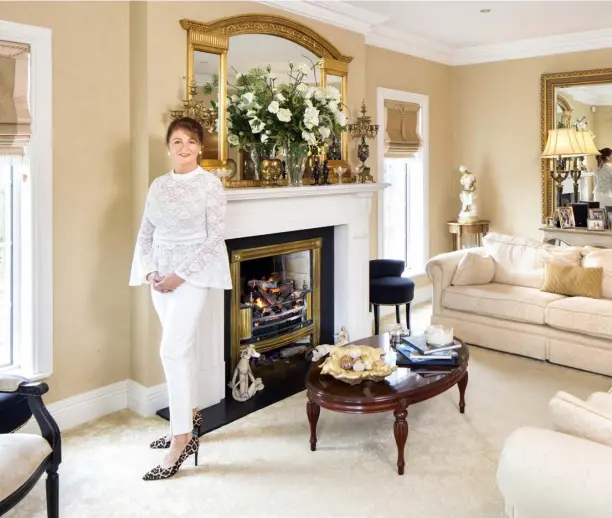  ??  ?? ABOVE: Karen in her elegant drawing room, with its cream sofas and cream carpet.The other accent colour is gold. The antique overmantel is from Alain Chawner Antiques in LouthMIDDL­E RIGHT: The TV room with its red leather sofas is probably the most practical room in the house, though the animal-print curtains add a trademark Karen touchRIGHT: The cream and gold bathroom is Karen’s favourite space in the house. “Before an event, if you ring my house at 2am, I’ll be in the bath, thinking it all through,” Karen says TOP RIGHT: The minstrels’ gallery above the spectacula­r hall was a recent addition and nearly brought the house down, but the day was saved when the builder added an RSJ (rolled steel joist). “I nearly ran away from home when I realised it wasn’t such a good idea to have the gallery, but it worked out in the end,” Karen notes