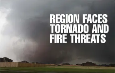  ?? Associated Press ?? ■ A tornado moves past homes May 20, 2013, in Moore, Okla. Emergency officials in Oklahoma, Texas and Kansas are bracing for the start of what’s historical­ly the most active time of year for tornadoes while also facing wildfire threats because of...