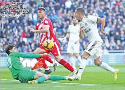  ?? - Gambar Reuters ?? PEMAIN Real Madrid Lucas Vazquez, melepaskan rembatan namun berjaya dihalang oleh penjaga gol Girona.