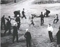  ??  ?? Const. Alex Hill is rushed as he tries to pull Det. Charles Millar to safety in the opening minutes of the historic Regina Riot of July 1, 1935.