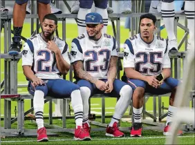  ?? MARK HUMPHREY/AP PHOTO ?? Patriots cornerback Malcolm Butler (21), strong safety Patrick Chung (23), and cornerback Eric Rowe (25) wait for their team photo on Saturday at Minneapoli­s.